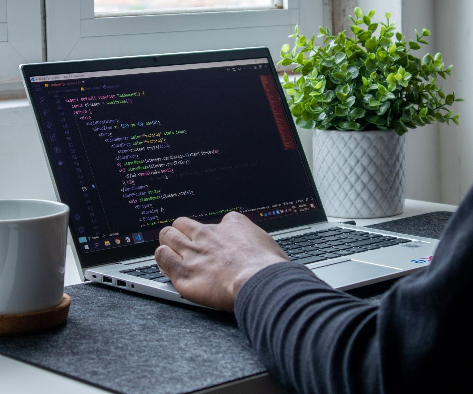 person using macbook pro on table